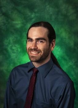 Photo of Logan Karwoski with a green background