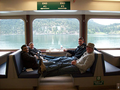 Four friends sitting together on a water ferry.