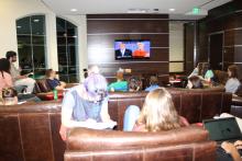 Students in lounge watching 2016 presidential debate on tv