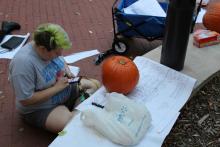 Student looking for pumpkin carving designs