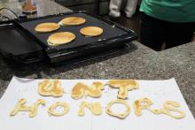 Pancakes shaped like the words "UNT Honors"