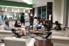 Students in lounge area eating pancakes