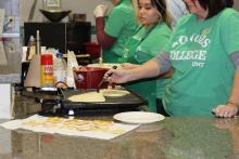 Honors College staff members making pancakes