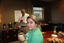 A student and Dr. Duban holding coffee cups