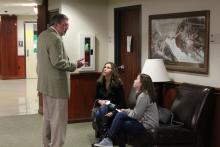 Dr. Duban speaking to a couple of students in Honors Hall