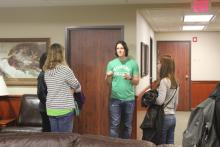 Students having a conversation in front of a door in Honors Hall