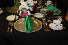 A place setting on a black table cloth