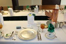 A place setting on a white table cloth